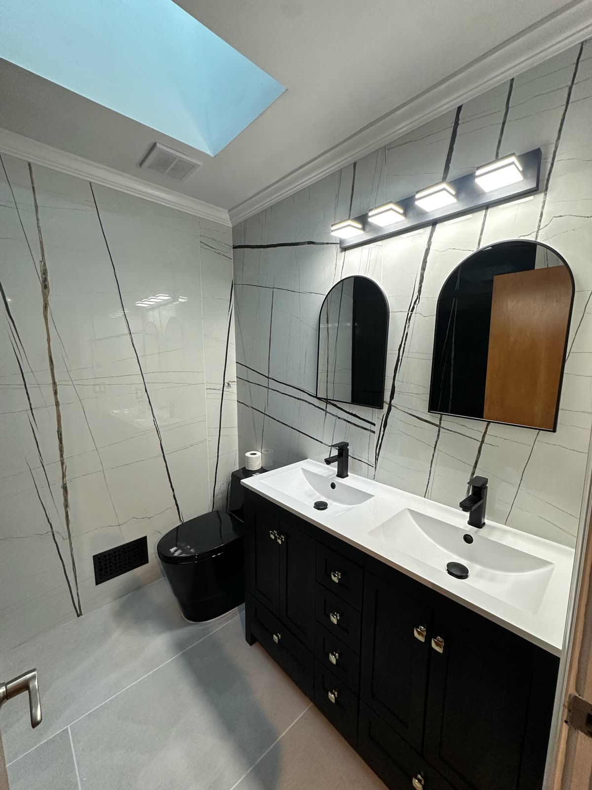 Real ARCED bathroom renovation with large-format wall tile and glass shower