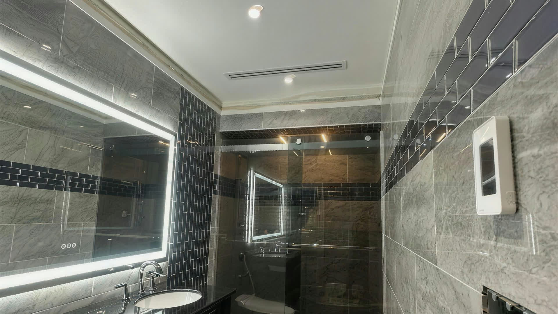 Real ARCED bathroom renovation — finished, facing the double vanity and glass shower